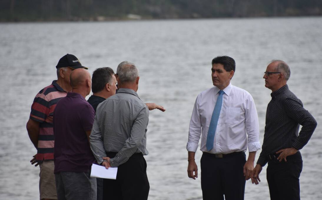 DISCUSSION: Geoff Lee and Greg Piper talk with Myuna Bay Water Ski Club officials during the December 12 announcement that the sport and rec centre would not reopen.