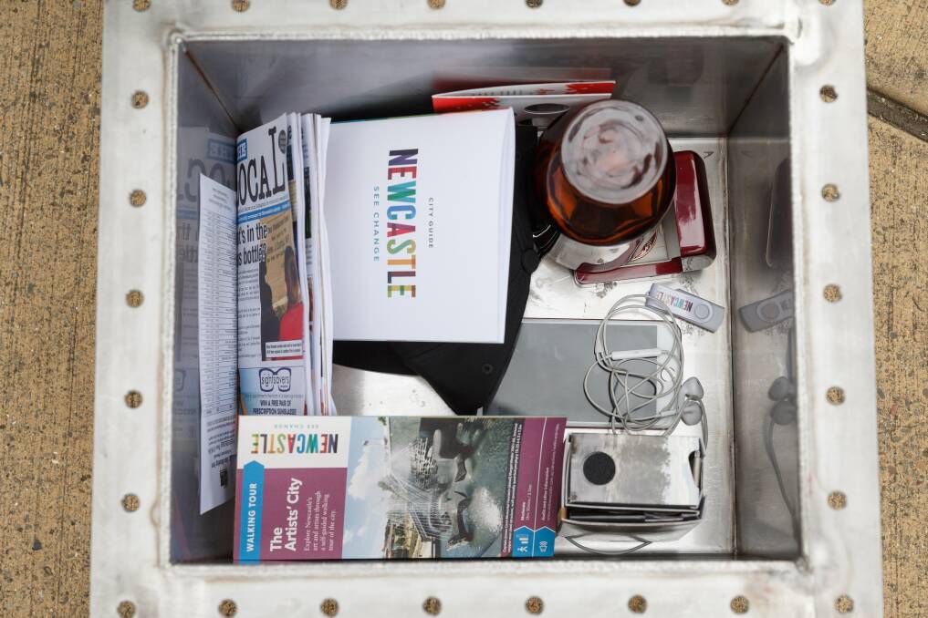 Some of the items that will go into the capsule, including USB sticks, editions of The Lambton Local, and photos of local school children. Picture: Max Mason-Hubers