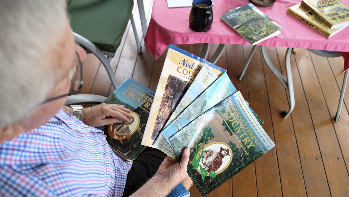 Valentine author Greg Powell with some of his earlier books on bushwalking.