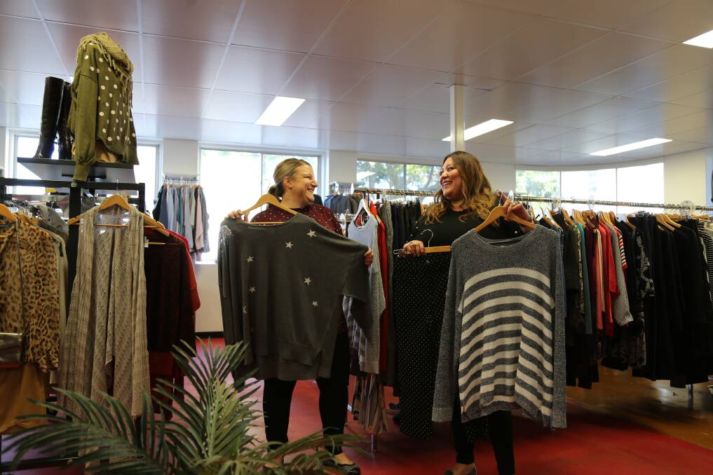 Bronwyn Pritchard and Norma Argueta with some of the donated Harris Scarfe clothes at the Hamilton North Lifeline store. Picture: Ellie-Marie Watts