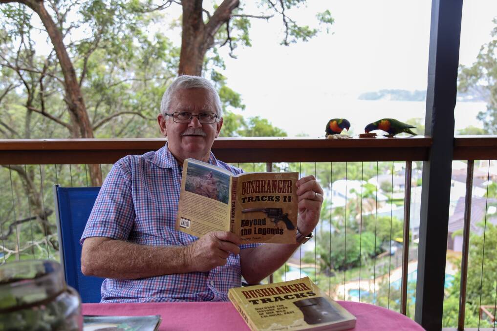 LIFE ACHIEVEMENT: Greg Powell at his Valentine home with his latest book, Bushranger Tracks II: Beyond the Legends. Picture: Ellie-Marie Watts