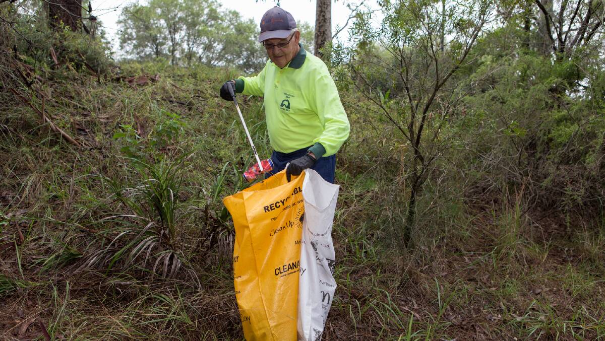 TIDY TOWN: A Clean Up Australia Day volunteer in Warners Bay in 2017. Clean Up Australia Day returns March 1. Picture: Lake Macquarie City Council