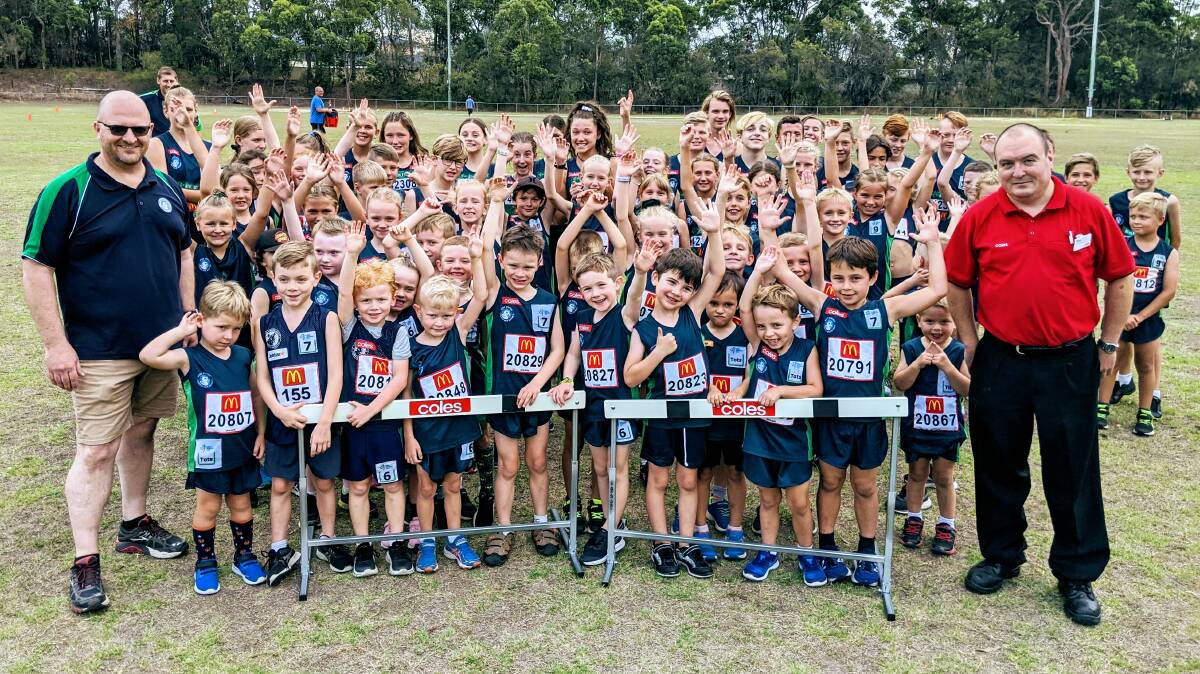 RUN FUNDS: Coles Warners Bay store support manager Steve Purdon, right, presented Cardiff and Districts Little Athletes Centre with their new hurdles last month. Picture: Supplied