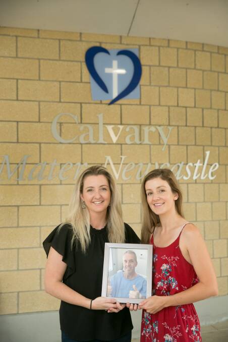 LOVING: Peter Cameron's daughters, Megan Baird and Lisa Eaton, at the Calvary Mater Hospital. On December 7, Mrs Baird will have her long locks lopped off to raise funds for the hospital's medical oncology clinical trials, which are self funded. Picture: Marina Neil
