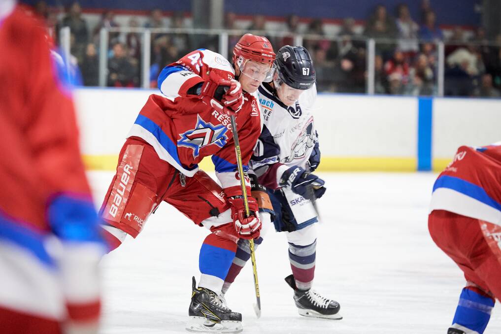 Luke Simpson battling a Sydney Ice Dogs player for the puck. Picture: PowerPlay Photographics