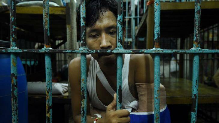 Wounded drug user Francisco Maneja 27, sits in a cell at Manila Police Headquarters.  Photo: Kate Geraghty