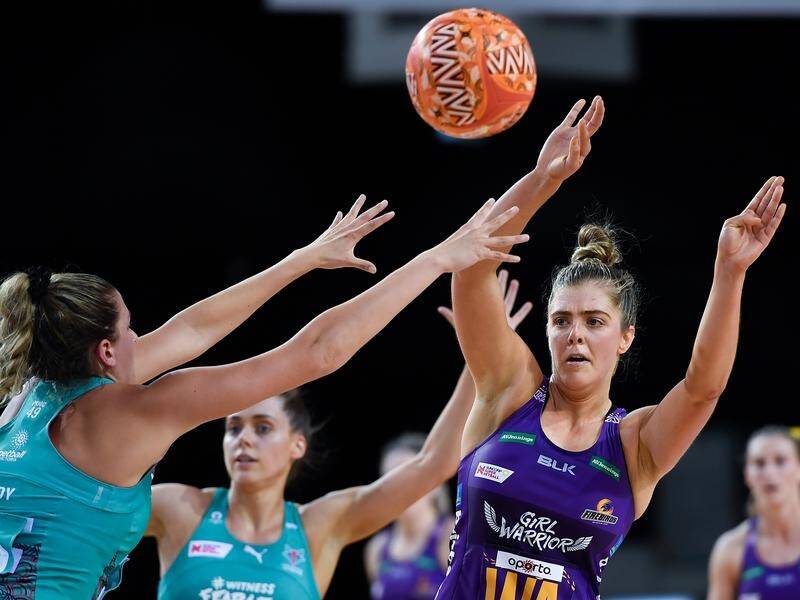 Lara Dunkley of the Firebirds makes a pass in their 64-58 win over the Melbourne Vixens on Sunday.
