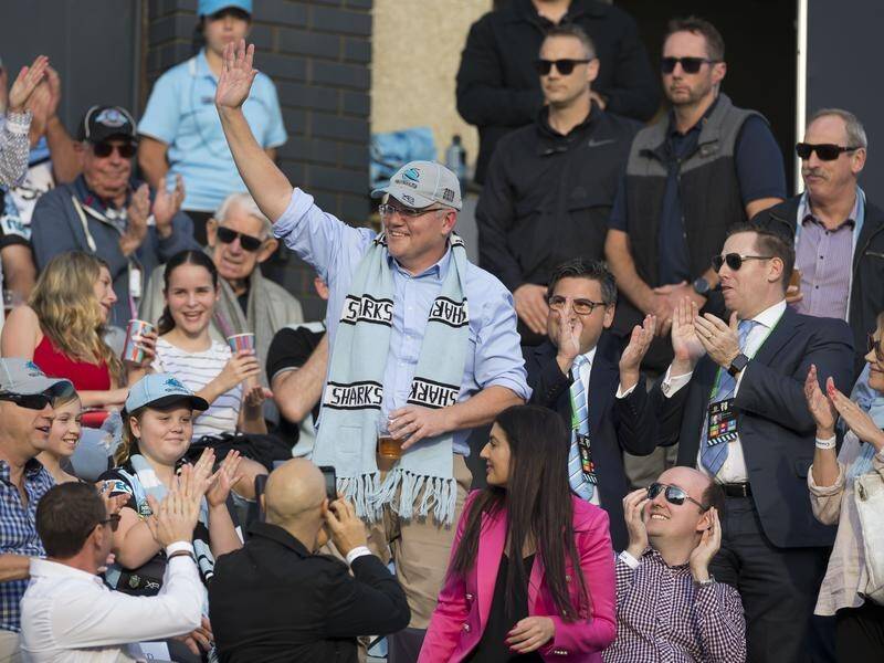 Cheering crowds have welcomed returning PM Scott Morrison to a football match in Cronulla.
