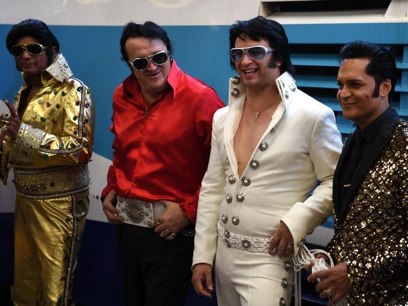 Elvis lookalikes and fans flooded Sydney's Central Station en route to the Parkes Elvis Festival.