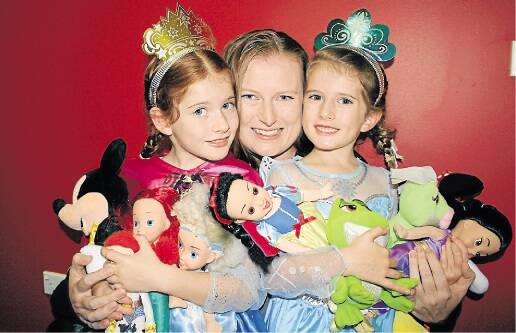 Cameron Park's Ellen Crossman and her daughters Megan, 7, and Jasmine, 6, with their Disney On Ice memorabilia.