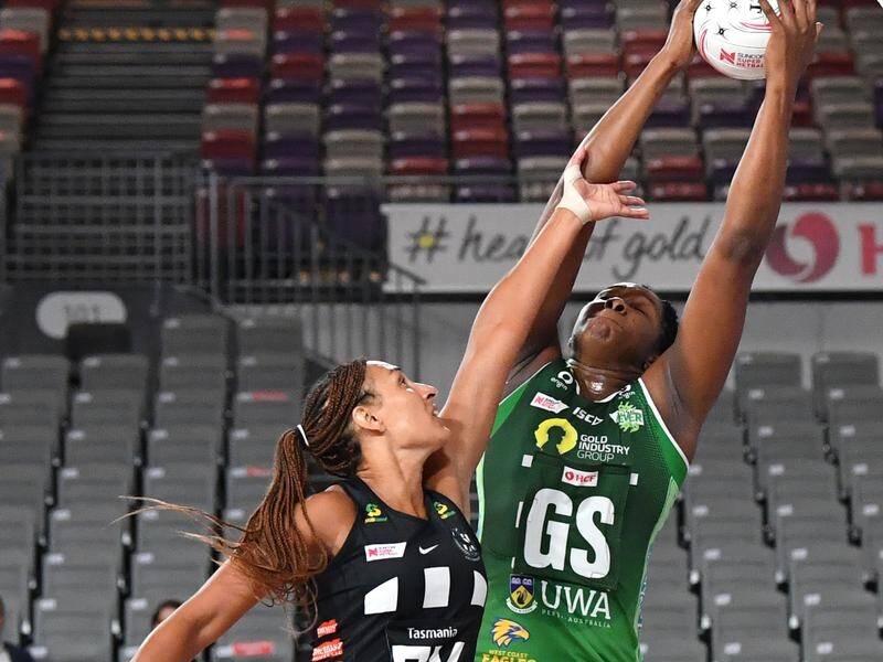 West Coast Fever's Jhaniele Fowler (right) gets the better of Magpie defender Geva Mentor.