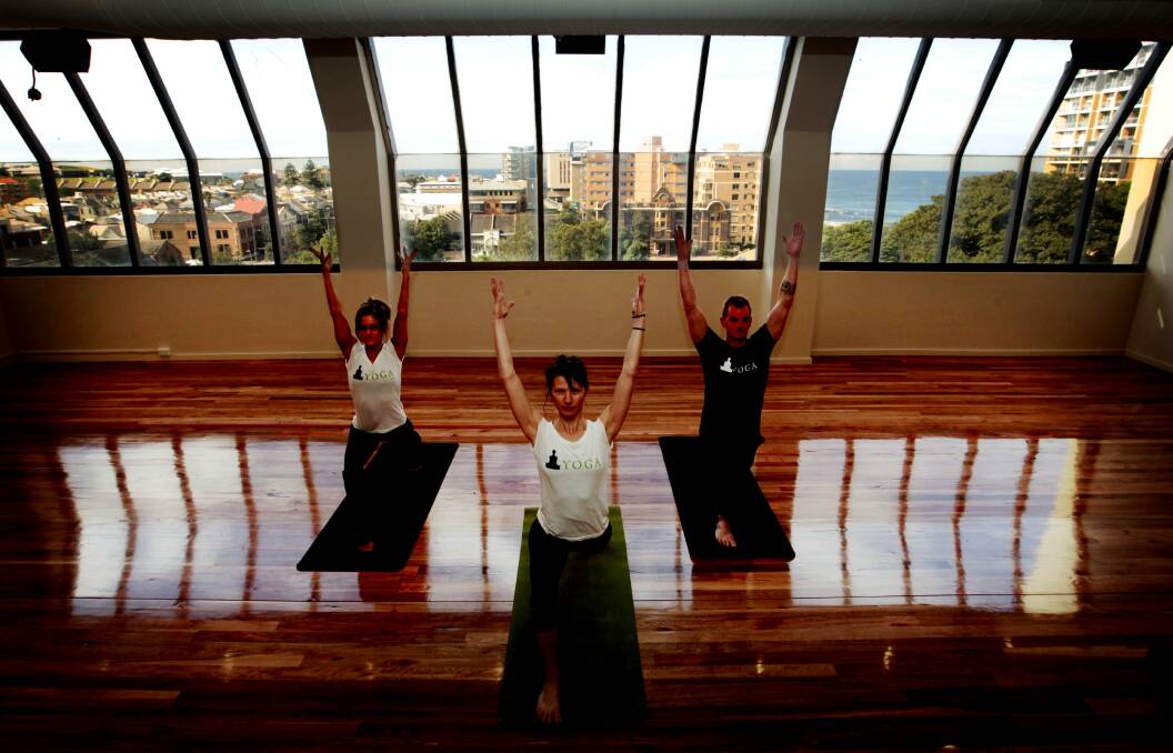 Yoga Loft owner and head teacher Cveta Jovanoska, centre, with  views of the beach and  harbour in the background.