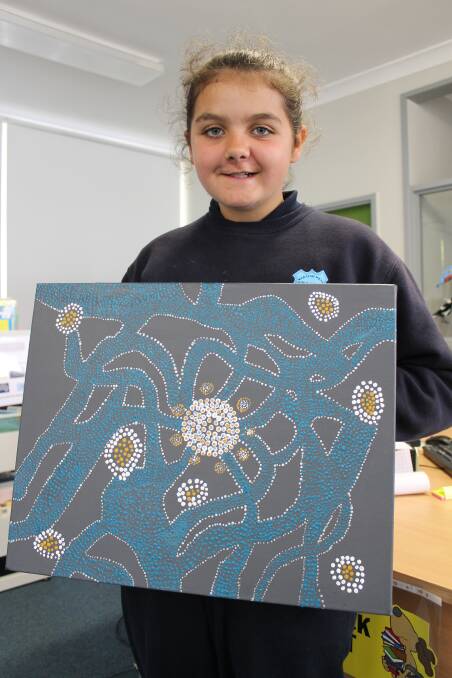 Tiara Dargin of Waratah West Public School shows off her artwork,