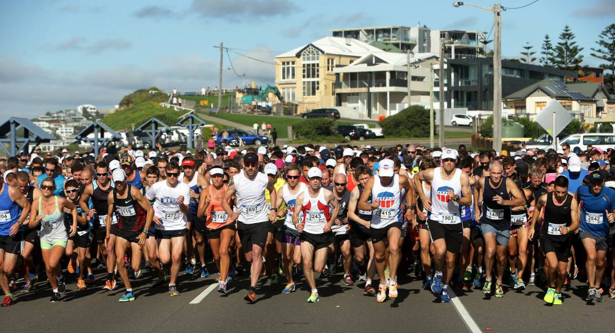 DETERMINED: Thousands of runners make the start for the Newcastle Herald's Hill-2-Harbour fun run from Bar Beach to Newcastle Foreshore, ignoring the earlier deluge.