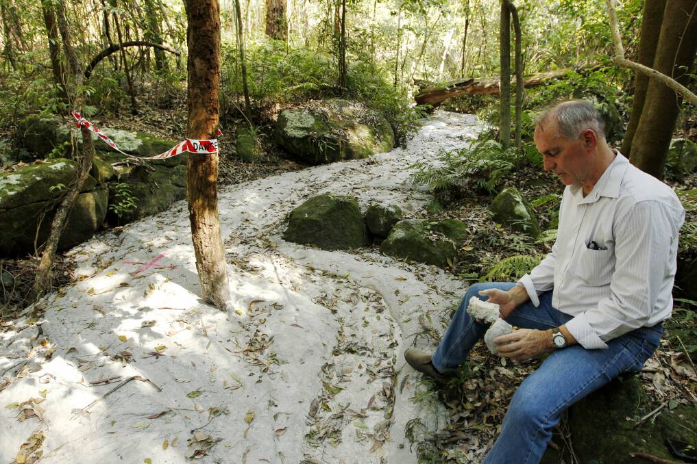 DRY: Lake Macquarie MP Greg Piper inspects a creek at the Sugarloaf State Conservation Area that was accidentally grouted during remediation works last year.