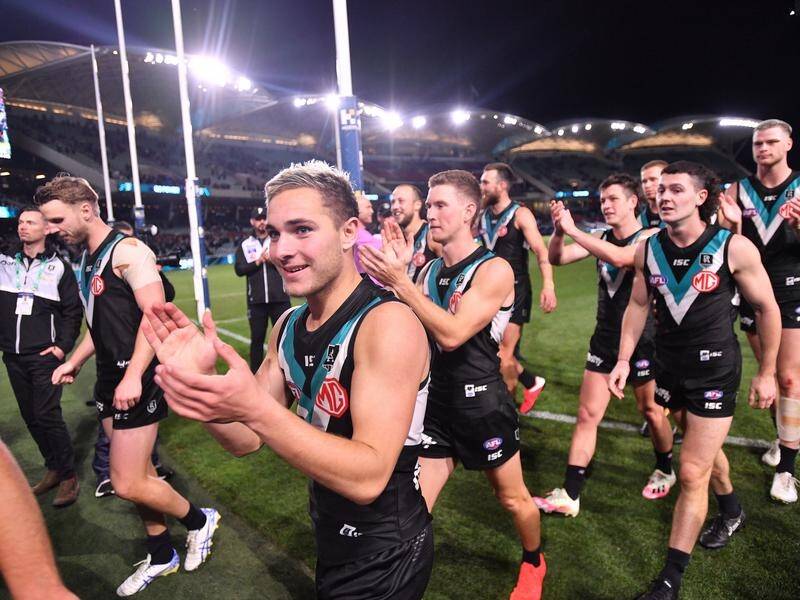 Port Adelaide players celebrate after beating Richmond by 21 points on Saturday.