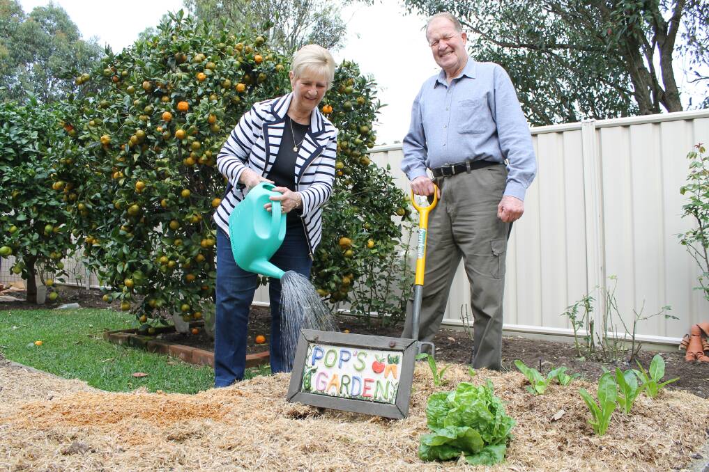 LOYAL CUSTOMERS: Long-time gardeners Pam and Gary Ellen in the vegetable patch at their Wallsend villa.
