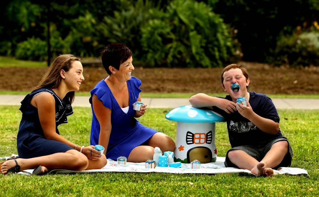 ACTIVE FAMILY: Michelle Finlay with her daughter Sophie and son Thomas promote the 2012 Light It Blue picnic.