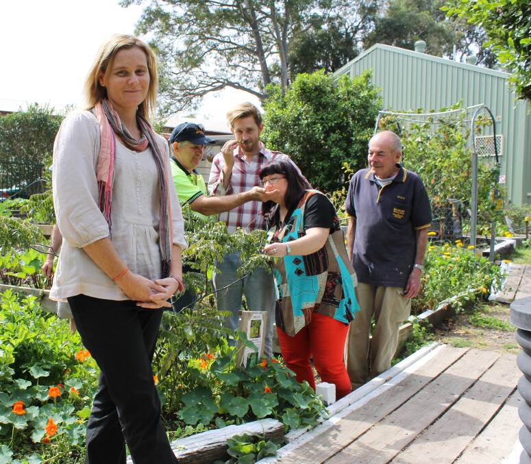 Belmont Neighbourhood Centre manager Sheena Harvey working with volunteers in the centre's community garden.