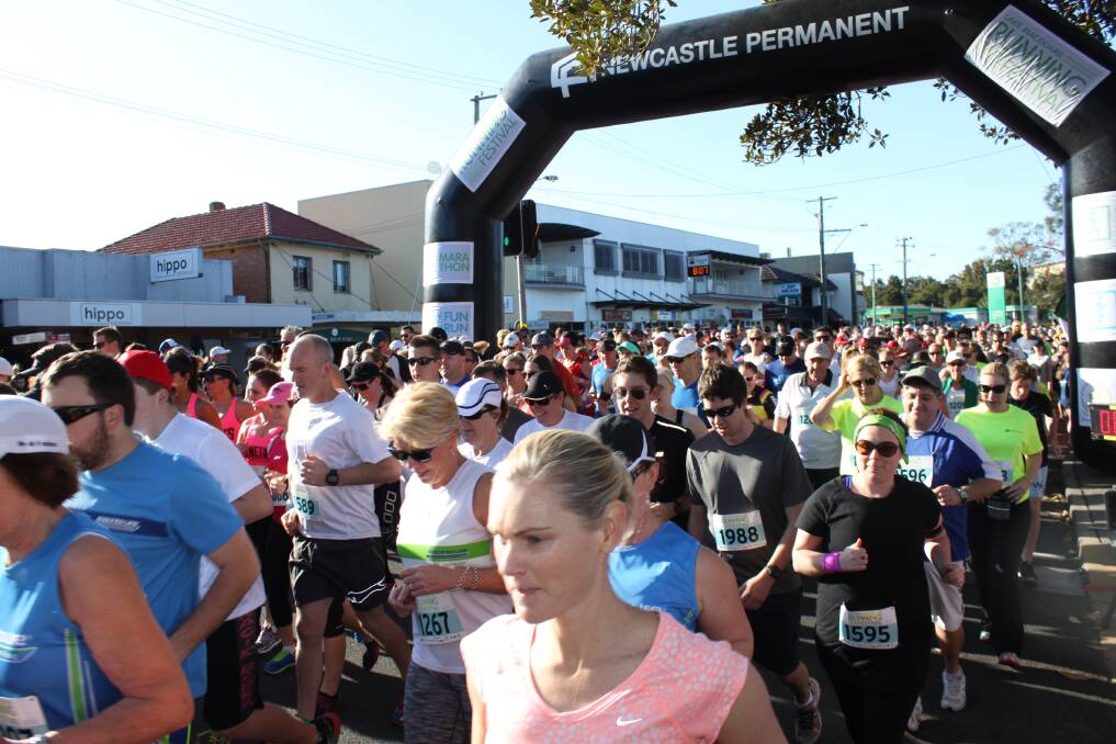 Entrants in the 2014 Lake Macquarie Running Festival's 10.5-kilometre fun run cross the start line. Merewether's Vladimir Shatrov won the half-marathon.