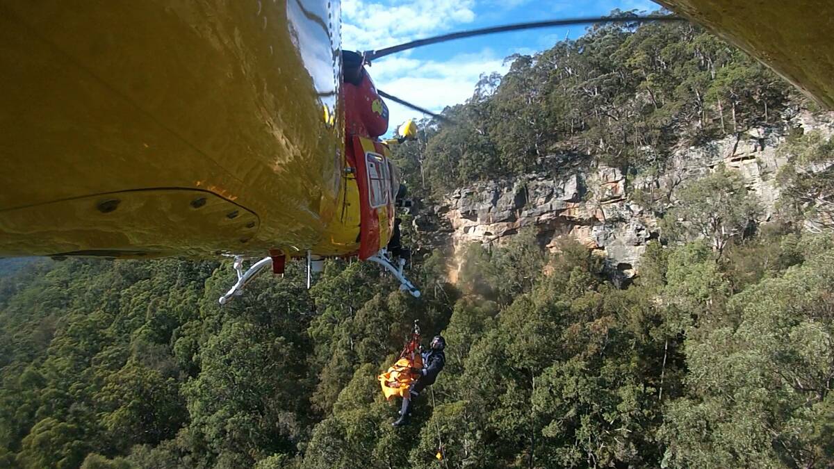 A boy is rescued by the Westpac helicopter after he fell down a cliff.