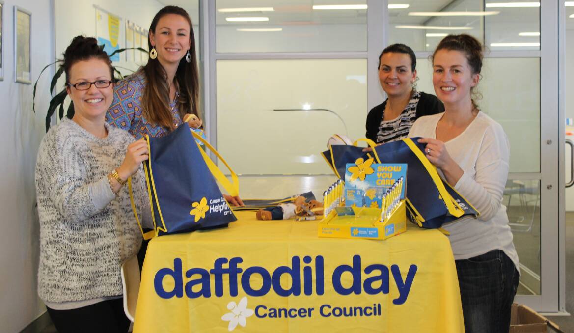 Elissa Mead, Kristi Gander, Nayerra Hudson and Leigh Buckland getting merchandise ready for Daffodil Day.