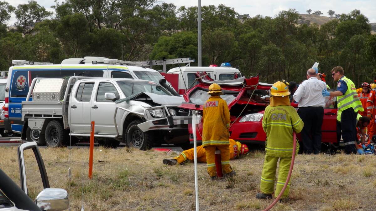 HORRIFIC: Emergency crews work at the Fogarty's Gap Road intersection. Picture: LEIGH SHARP