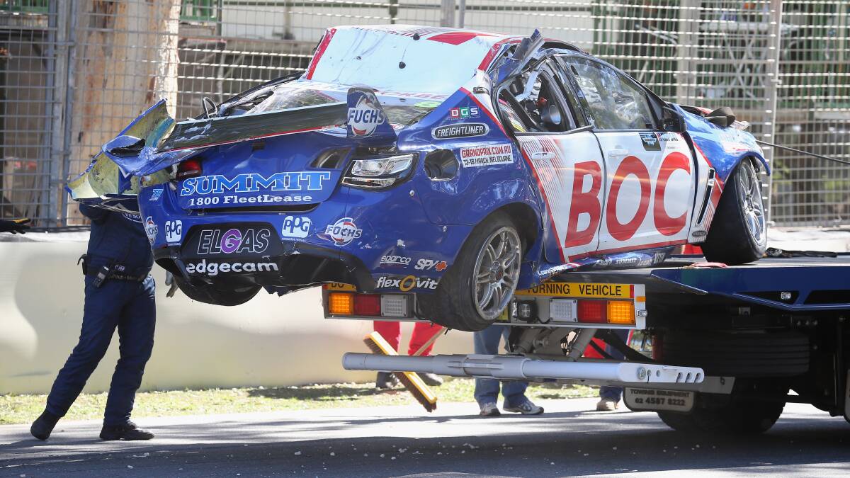  The #8 Team BOC Holden of Jason Bright is removed from the track after a rollover during race three of the Clipsal 500.