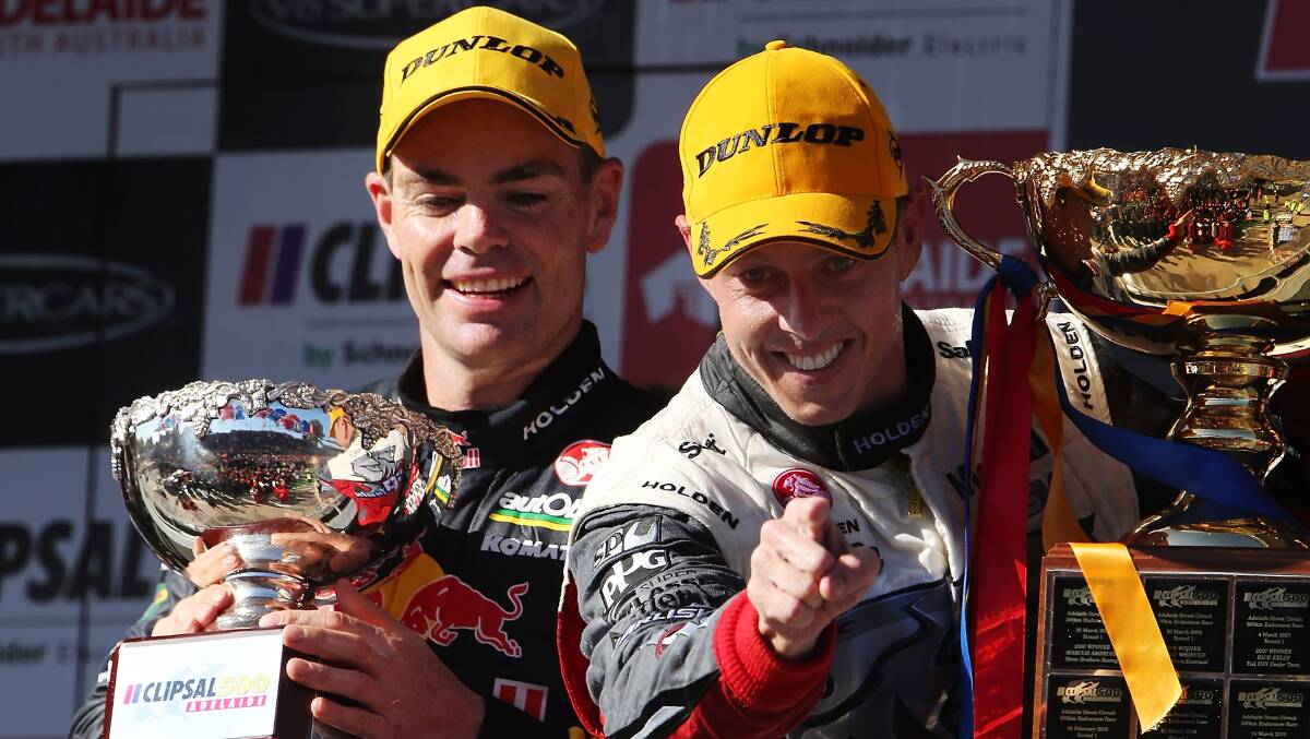 Craig Lowndes,  driver of the #888 Red Bull Racing Australia Holden, celebrates on the podium with James Courtney, driver of the #22 Holden Racing Team, after winning race three of the V8 Supercars Championship Series at the Clipsal 500 in Adelaide. Picture: Getty