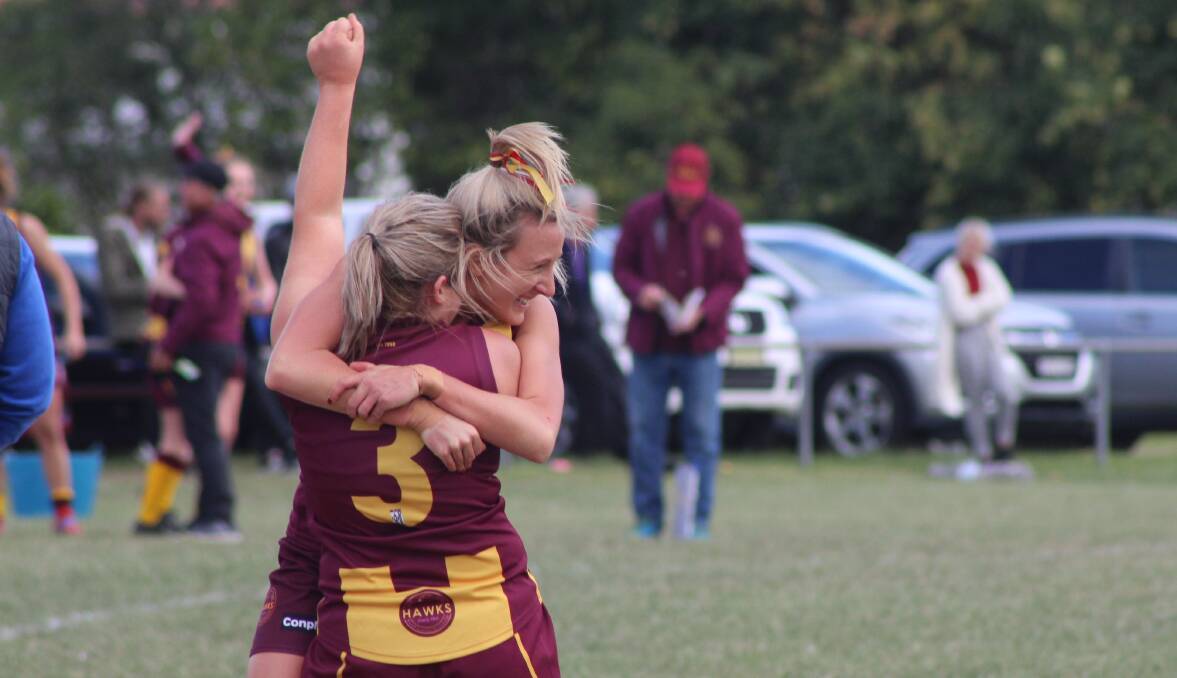 CELEBRATION: Sheree Vukovich and Abbey Cooksley celebrate after the Cardiff Hawks soared to their first win of the year, downing Lake Macquarie Dockers 10.10 (70) to 5.6 (36). Picture: Isaac McIntyre