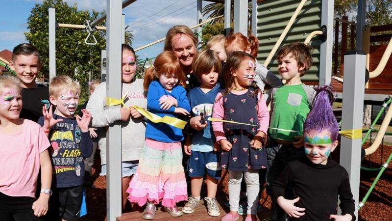 Nuatali Nelmes at Grahame Park, Carrington, alongside a number of youngster taking full advantage of the new and upgraded playgrounds.