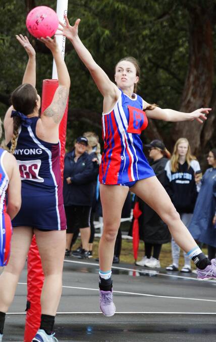 Goal keeper Sharla Barnard attempts a soaring block against Wyong's shooter on Sunday. Picture: Kerrie Brady