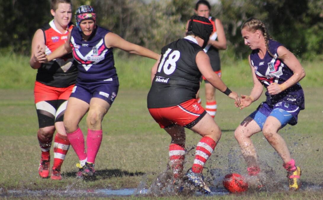 MUDDY: Wallsend-West Newcastle's Sarah Leslie and Lake Macquarie's five-star Emma-Jayne Howe contest a ball at Tulkaba Park as the Dockers recorded their first win of the season. Picture: Pauly Bluey