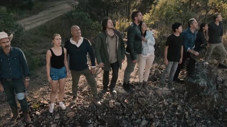 The cast of Occupation during the film's opening scenes. Newcastle's Zac Garred (pictured in green jacket) starred as homelessman Dennis in the first movie. Picture: screenshot.