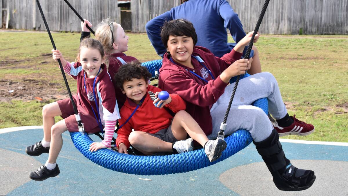 WIDE SMILES: Belmont North Public School students joined may Kay Fraser for a morning of 'testing' the new Luskin Way play equipment.