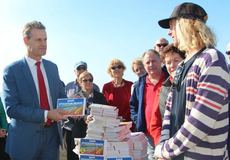 GOOD NEWS: Tim Crakanthorp at Stockton Beach to announce the petition had reached the necessary 10,000 signatures.