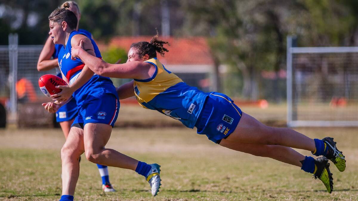 UNBEATABLE?: Nelson Bay faced a tough battle against Warners Bay at Feighan Park, but emerged undefeated after twelve rounds of the Black Diamond AFL Womens. Pictured is Jemma Astley diving for a tackle in the clash. Picture: Ken Hogan