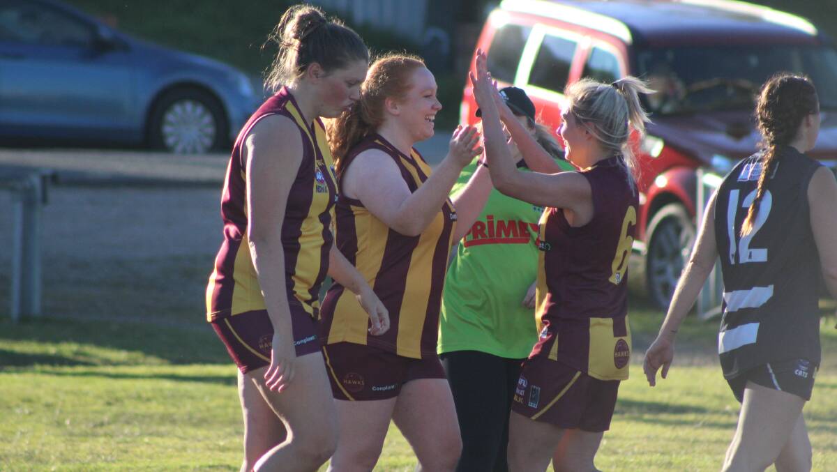 The Hawks celebrate one of Nicola Breward's two goals against the Cats.