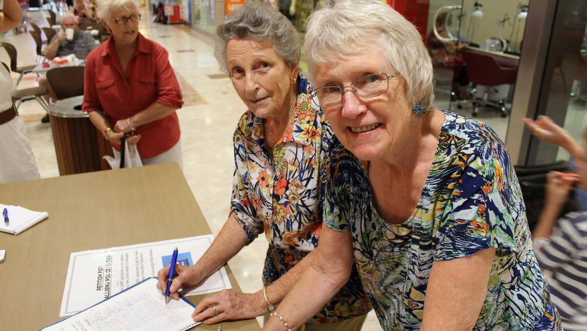 SUPPORTERS: Shirley Pettett and Margaret Micallef sign a petition to have a police station established in Wallsend.