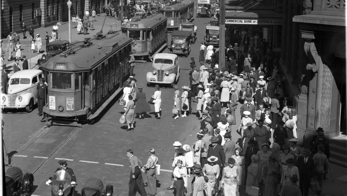 OLD CBD: Shopping crowds mingle with traffic, including light rail, in Hunter Street between Bolton and Watt Streets, November 6, 1947.