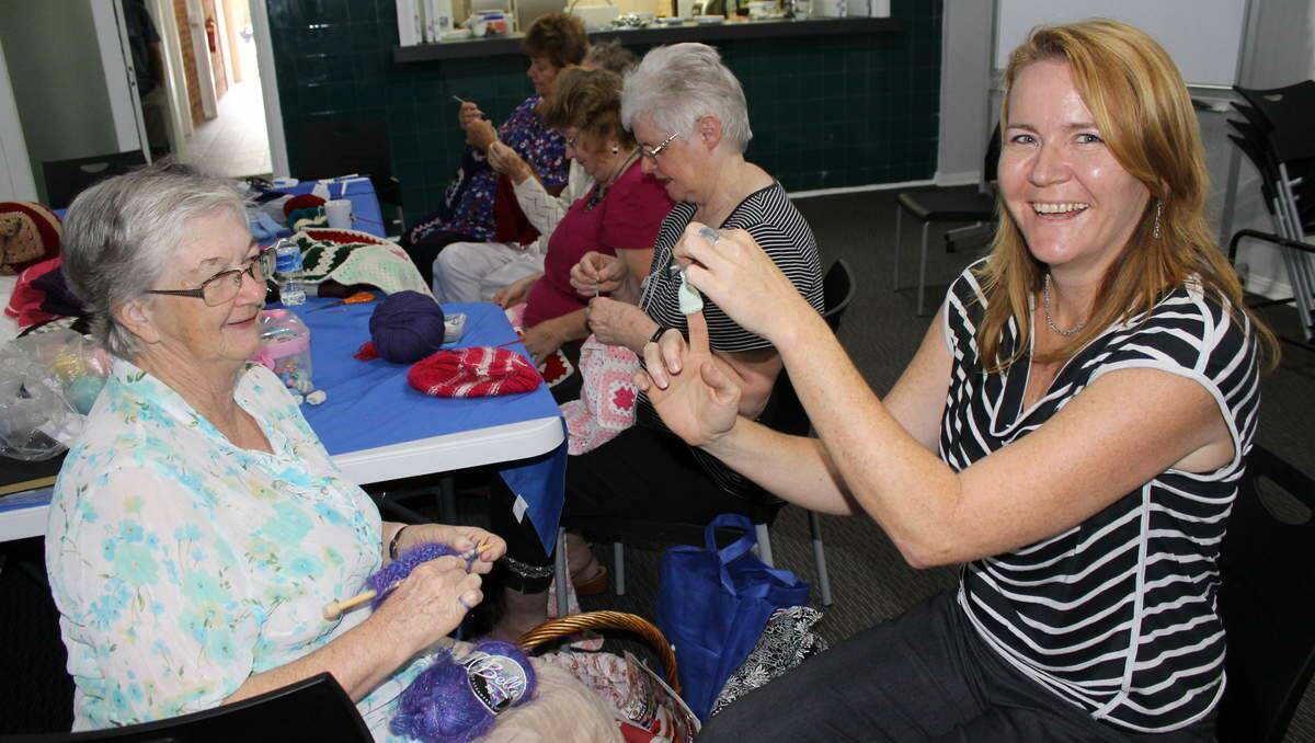 Minmi Crochet/Craft Group member Elaine Whittaker, of Toronto, with Lucy Andrews, of Compass Housing Services. 