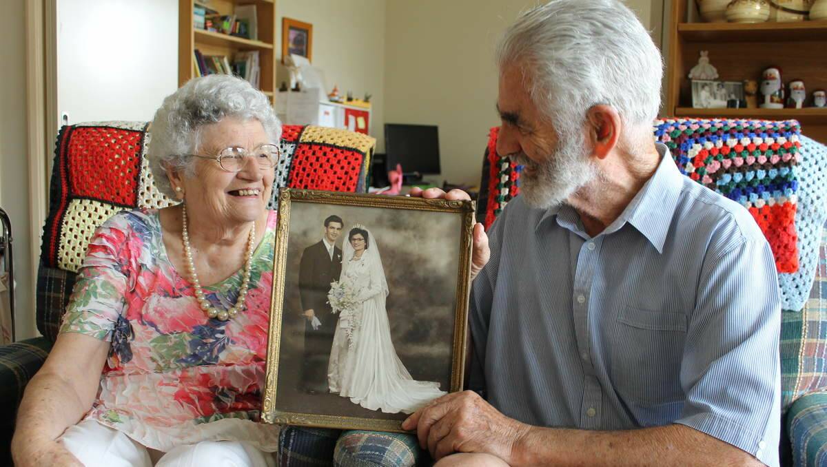 ENDURING LOVE: Anglican Care residents Bruce and Margaret Dunne hold a picture from their wedding, 60 years ago.