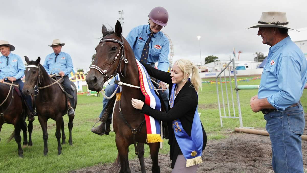 Sashing winners at the show is one of the many duties of the Newcastle showgirl.